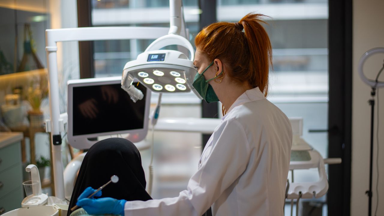 Equipa de clínica dentária em Lisboa a receber um paciente na sala de tratamento