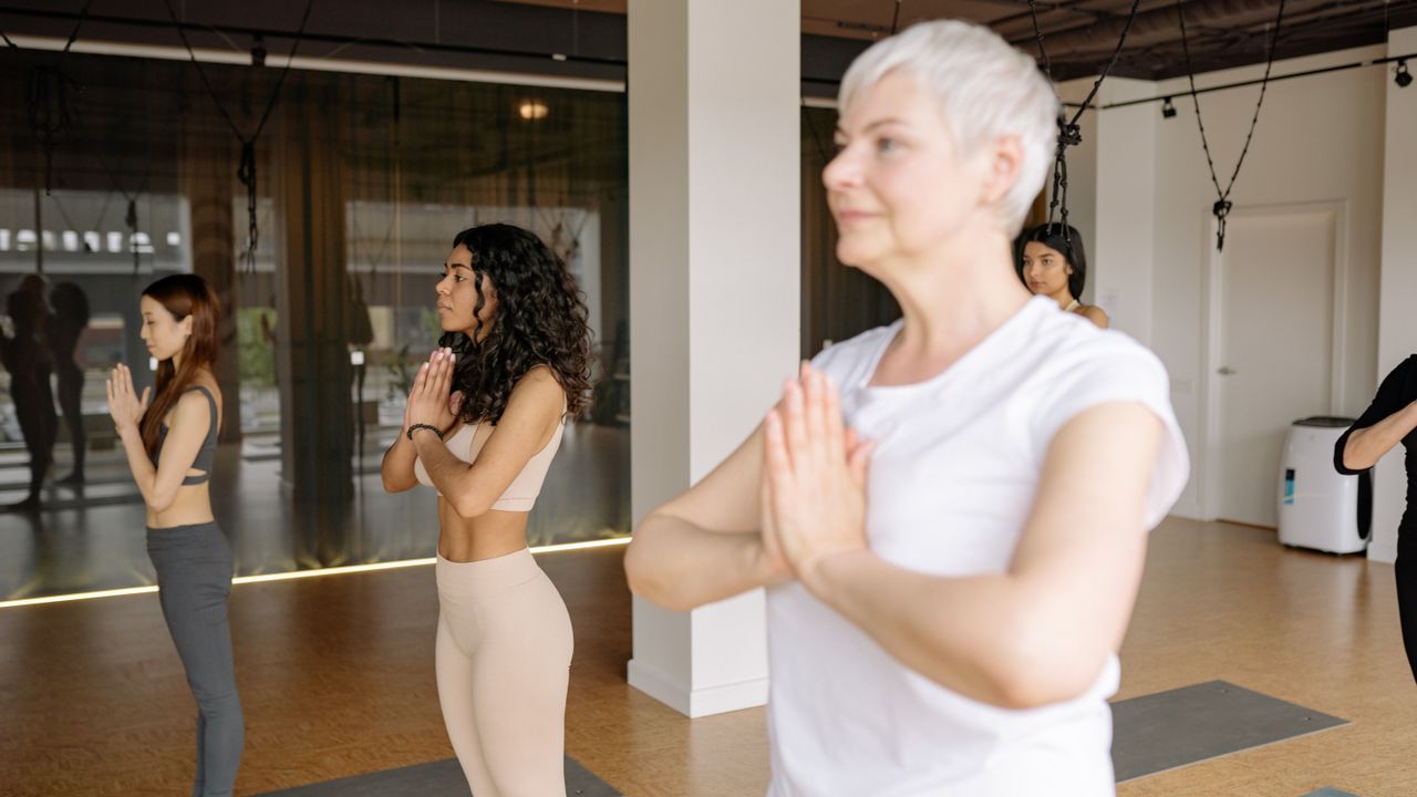 Instrutora a orientar uma aula de Yoga num estúdio em Lisboa